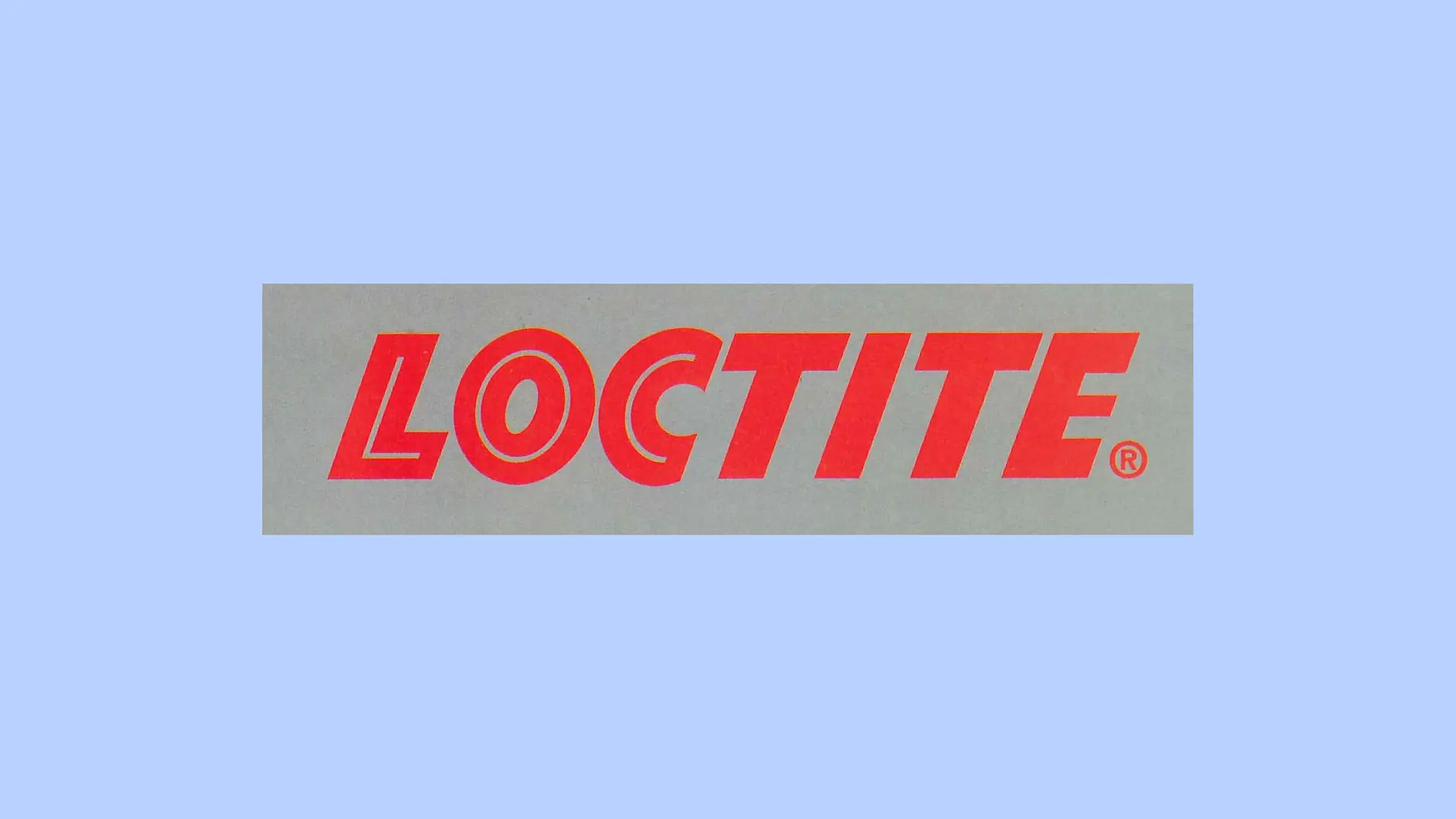 Červené logo Loctite na sivom pozadí.